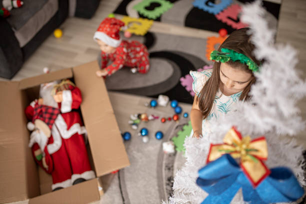istock Little girl decorates a Christmas Tree 1271975579