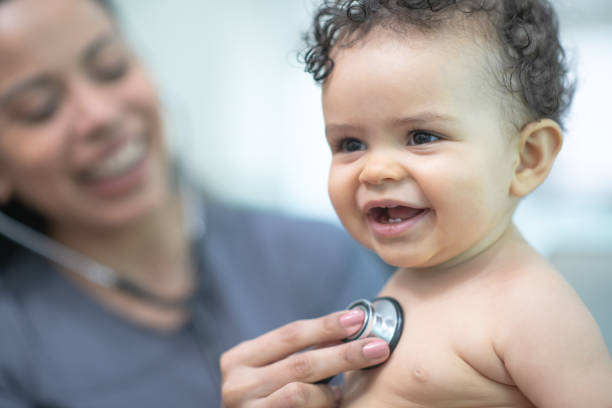 istock Visiting nurse checks on baby 1271975587