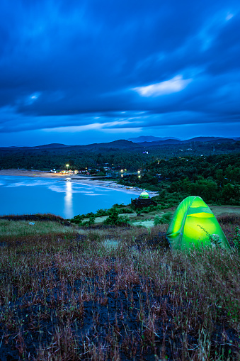 camping solo at mountain top with an amazing view and dramatic sky at the evening image is taken at gokarna karnataka india.