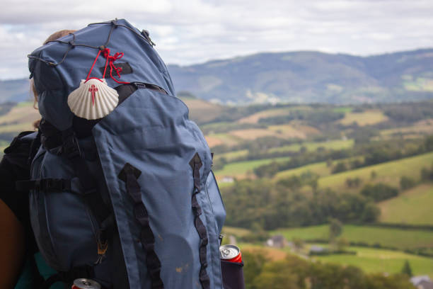 Big backpack with pilgrim shell on mountain background. Pilgrimage concept. Pilgrim on Camino de Santiago road. Tourist with rucksack on beautiful landscape background. Religious travel. Big backpack with pilgrim shell on mountain background. Pilgrimage concept. Pilgrim on Camino de Santiago road. Tourist with rucksack on beautiful landscape background. Religious travel. Backpacker in mountains. camino de santiago photos stock pictures, royalty-free photos & images