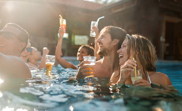 istock Happy young friends having pool party 1271978472
