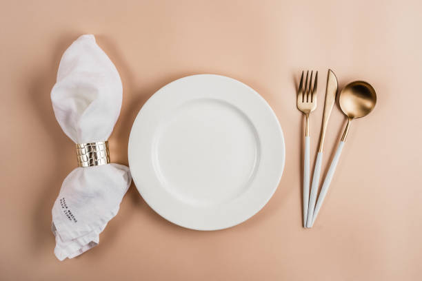 istock Festive Christmas, Wedding or Birthday table setting with golden cutlery 1271981404