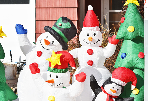 Inflatable snowman and friends in the front yard.
