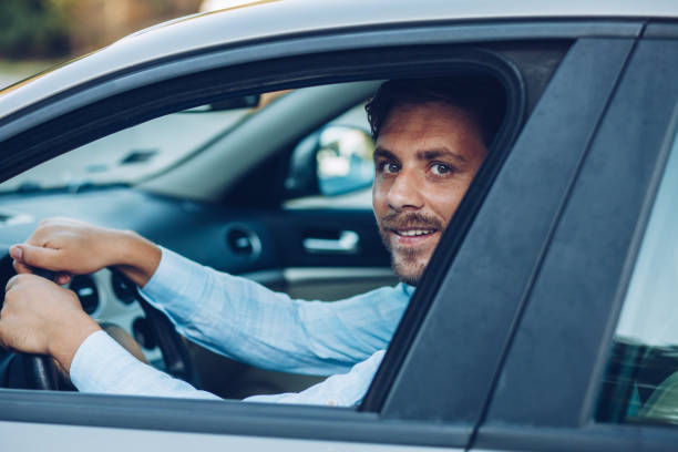 istock Young pensive businessman driving a car 1271981488