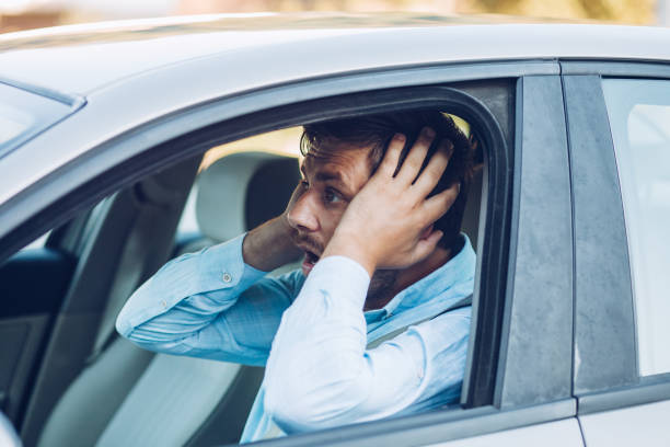 istock Young pensive businessman driving a car 1271981489