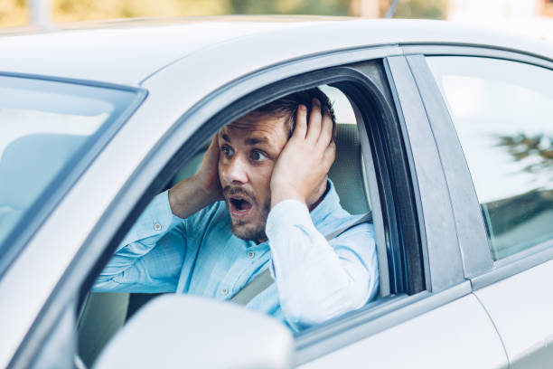 istock Young pensive businessman driving a car 1271981610