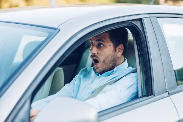 istock Young pensive businessman driving a car 1271981667