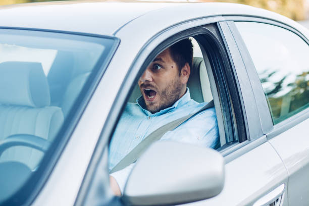 istock Young pensive businessman driving a car 1271981723
