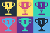 istock Pop art Award cup icon isolated on color background. Winner trophy symbol. Championship or competition trophy. Sports achievement sign. Vector 1271982339