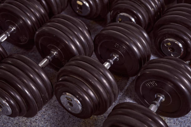 istock Sporting dumbbells on the grey floor. Advertising photo 1271990071