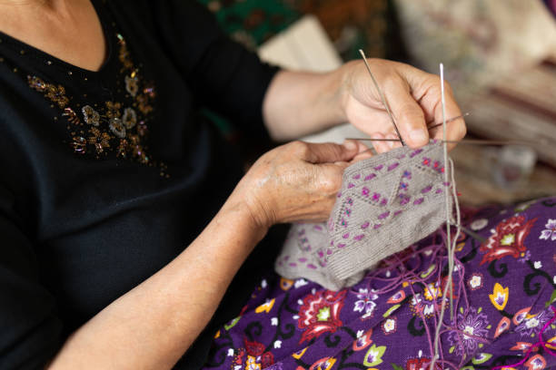 istock Close up on senior woman's hands knitting 1271991739