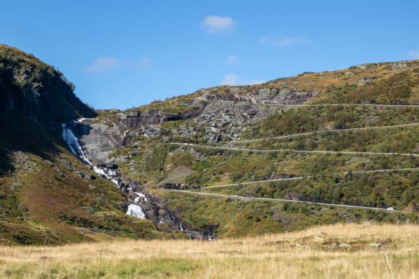 istock Norway serpentine mountain road with waterfall 1271992361