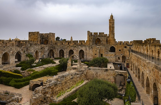 East Jerusalem, Palestine, May 2, 2019: Vie of the Tower of David - an ancient citadel located near the Jaffa Gate, the entrance to the Old City of Jerusalem, under cloudy sky.