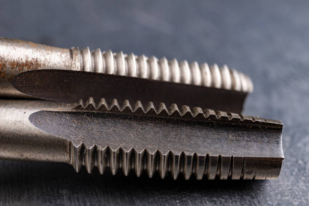 istock Metal thread cutting tools. Tool steel accessories for locksmiths. Light background. 1271992734