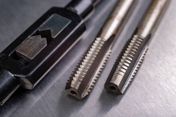 istock Metal thread cutting tools. Tool steel accessories for locksmiths. Light background. 1271992756