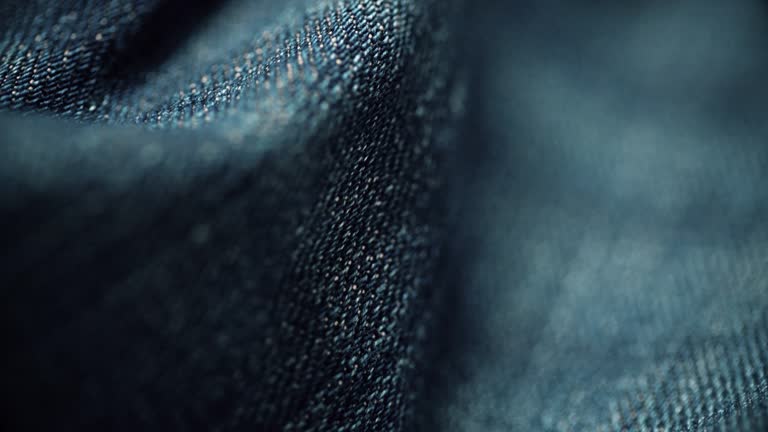 Denim material texture close-up. Dolly shot