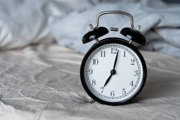 istock Stylish alarm clock with a bell. The hands show 7 hours. Wake up time 1271994918