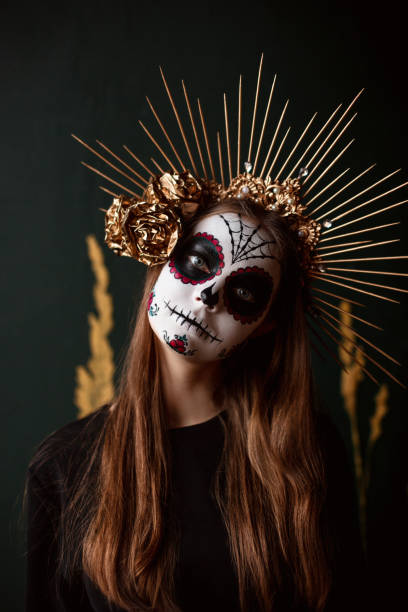 istock Attractive young woman with sugar skull makeup on dark background 1271999654