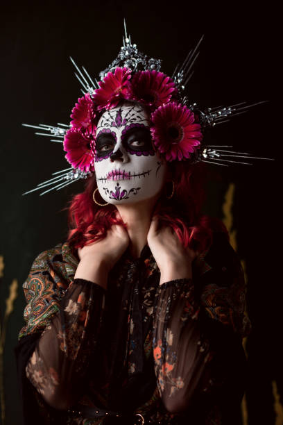 istock Attractive young woman with sugar skull makeup on dark background 1271999748