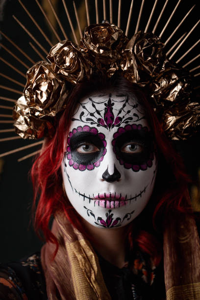 istock Attractive young woman with sugar skull makeup on dark background 1271999769