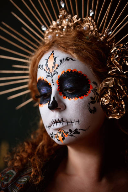 istock Attractive young woman with sugar skull makeup on dark background 1271999780
