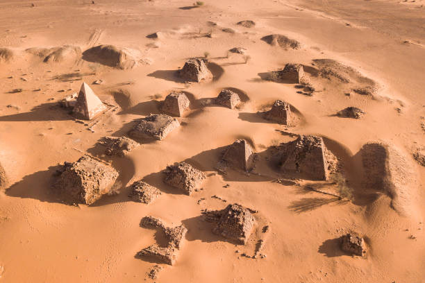 A group of pyramids at Meroe in Sudan embedded in sand dunes photographed from drone