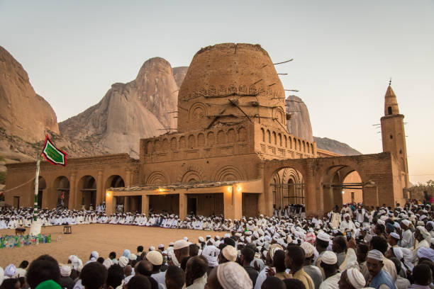 People gather at Khatmiya mosque in Kassala in Sudan to celebrate the birthday of prophet Mohammed The beautiful architecture and the setting on foot of the Taka mountains, huge granite rocks rounded by erosion, make it exceptional. It was damaged in 1885 and is currently not used for regular service, but for important ceremonies only. sudan stock pictures, royalty-free photos & images