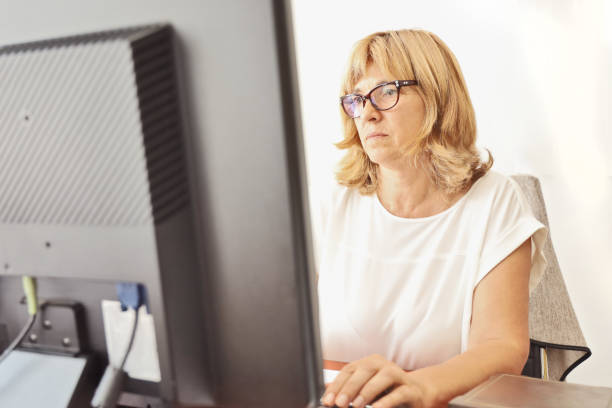istock Mature Woman Librarian at her work 1272000732