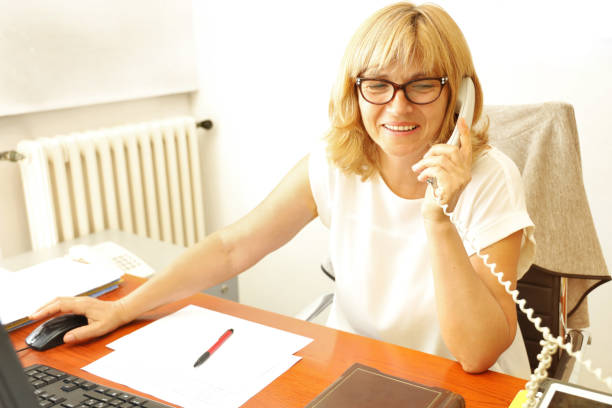 istock Mature Woman Librarian at her work 1272001030