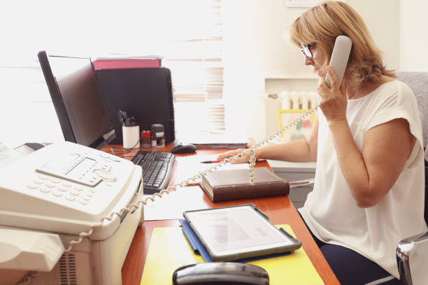 istock Mature Woman Librarian at her work 1272001061