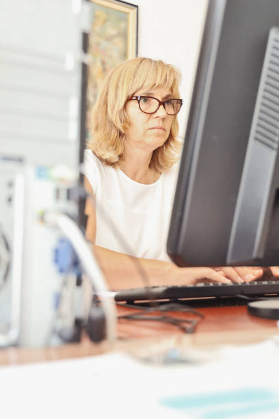 istock Mature Woman Librarian at her work 1272001598