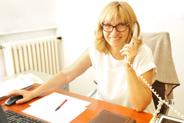 istock Mature Woman Librarian at her work 1272001640