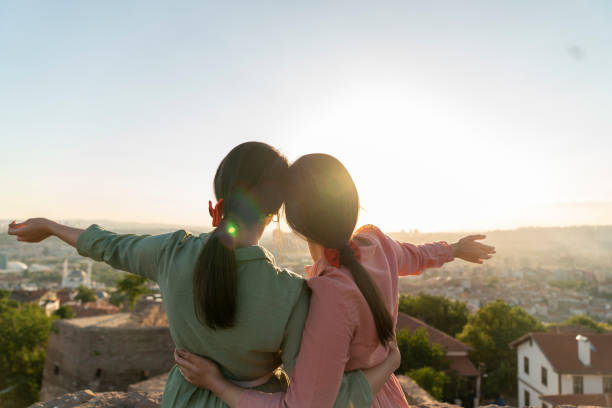 istock Two girls on sunset background. Best friends. 1272002073