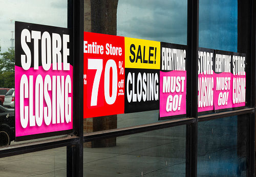 Horizontal shot of Going Out of Business signs in a retail store\