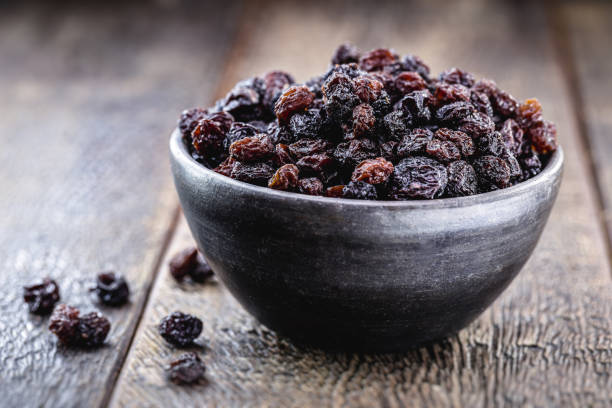 pot of brazilian raisin, candied fruit used in sweets, inside a handmade clay pot stock photo