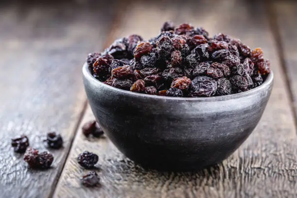 Photo of pot of brazilian raisin, candied fruit used in sweets, inside a handmade clay pot