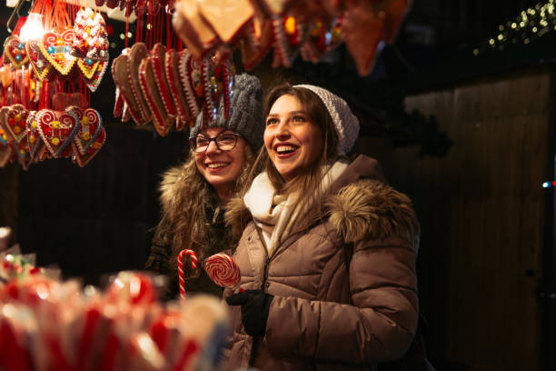 istock Young female friends looking at sweets on Christmas night 1272008730