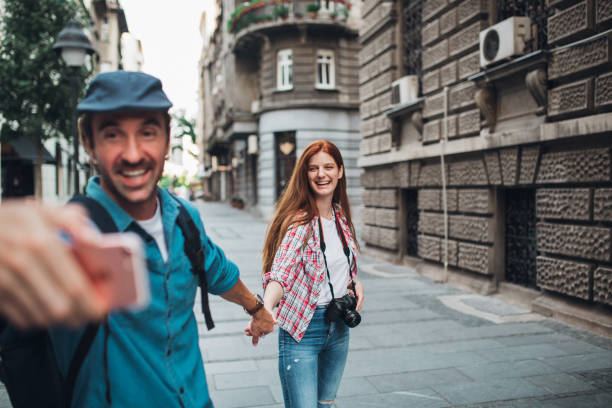 istock Happy couple on honeymoon taking selfies and enjoying 1272010630