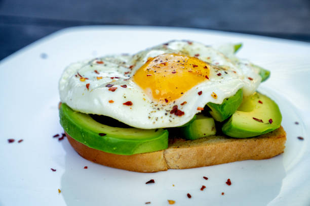 istock Open-Face Fried Egg Sandwich with Keto Bread and Avocado Slices for a Healthy Low Carb Breakfast 1272011334