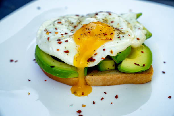 istock Open-Face Fried Egg Sandwich with Keto Bread and Avocado Slices for a Healthy Low Carb Breakfast 1272011348
