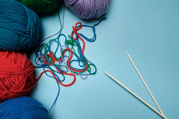 istock Group of various yarn balls and knitting needles closeup 1272011369