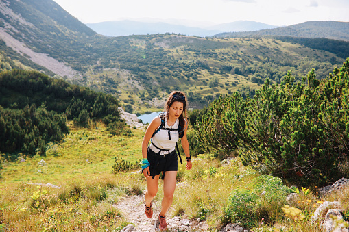 Woman hiking in the great outdoors, in the Dynamic Alps in Southern Europe.