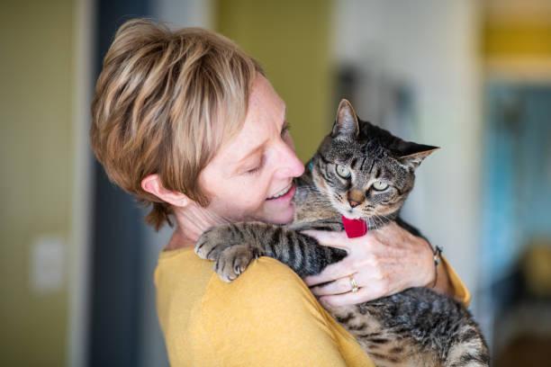 istock Woman Holding Her Cat 1272014780