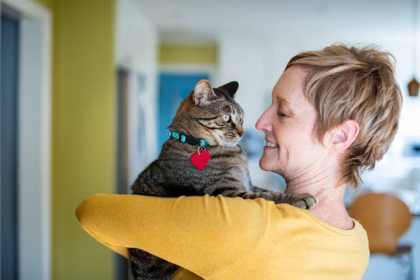 istock Woman Holding Her Cat 1272014795