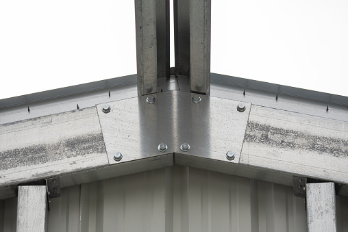 Cold-rolled steel framing joined together with nuts and bolts, while self-tapping screws are used to fasten Sheetmetal panels to crossmembers. Photo taken in High Springs, Florida. Nikon D750 with Nikon 200mm macro lens