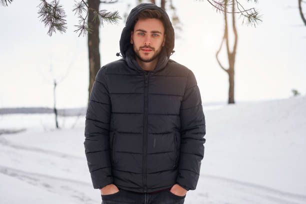 istock Attractive bearded man standing outdoors in winter season forest. 1272017101