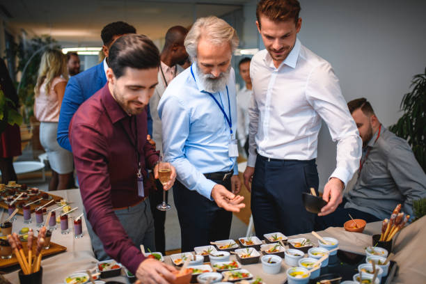 istock Businessmen Deciding on Appetizers at Office Party 1272017289