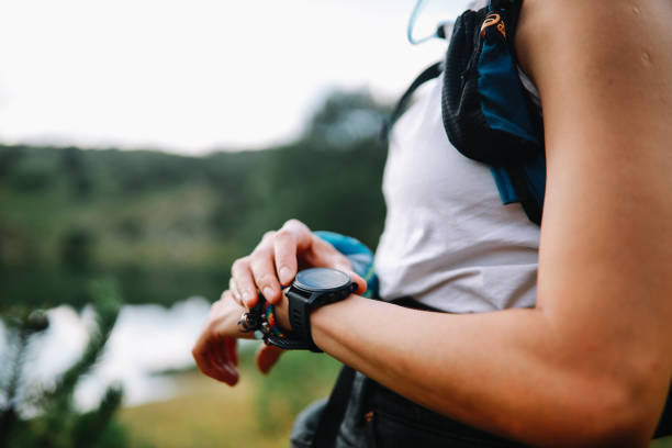 istock Young woman using a smart watch during the hiking trip 1272018136