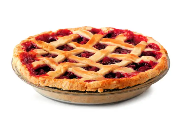 Photo of Homemade cherry pie with lattice pastry isolated on white