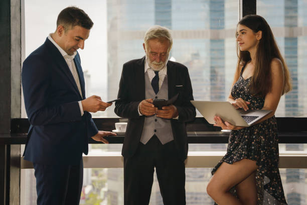 istock caucasian business people standing and having business discussion together with computer laptop on hand 1272019021
